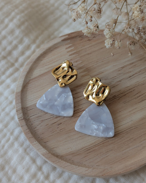boucles d'oreilles Mae clou d'oreilles carré ondulé et acétate effet marbré perlé blanc. Posées sur support en bois. Création La Tête dans les nétoiles