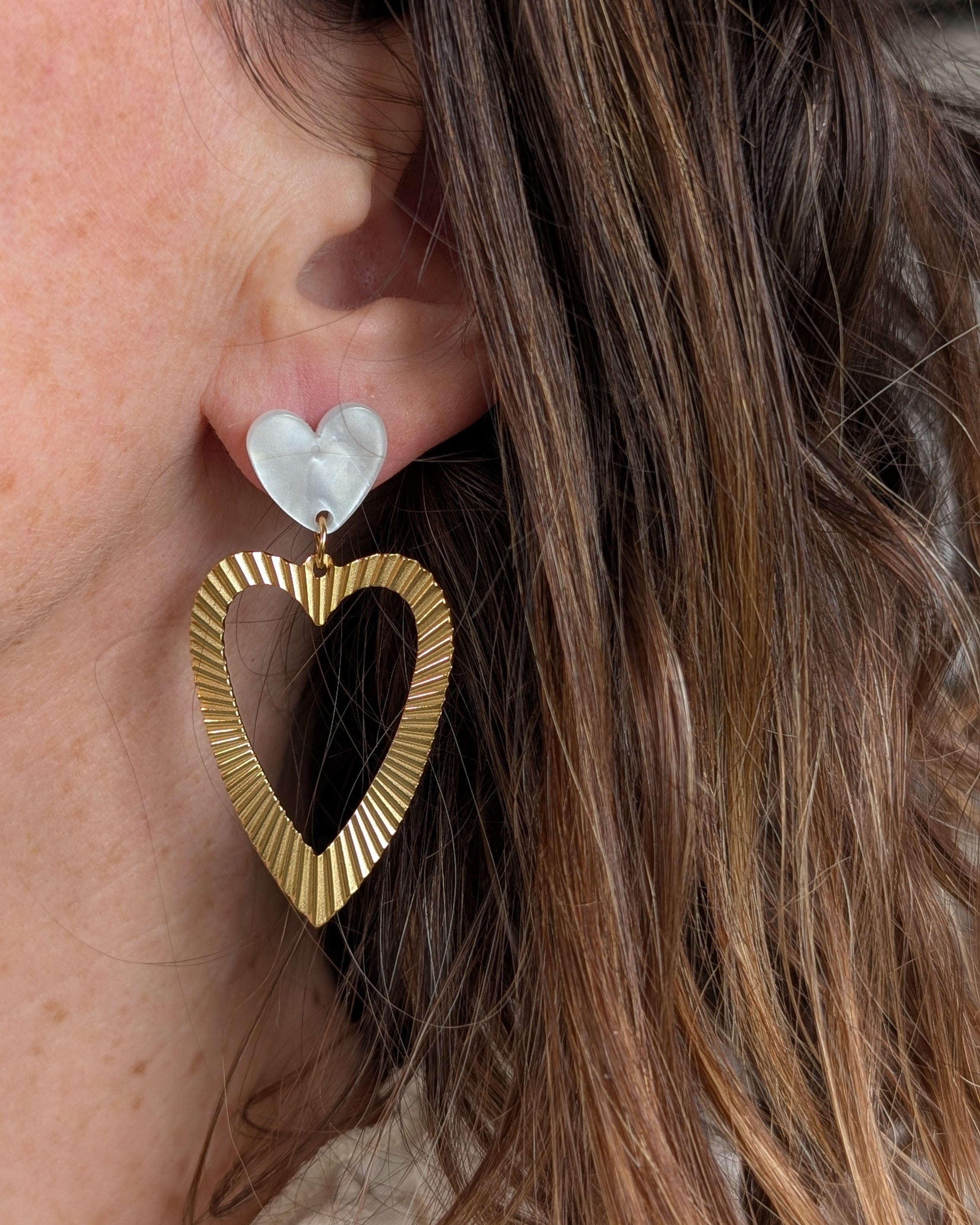 Boucles pendantes coeur Thelma blan nacre photo portee par une femme creation artisanale la Tete dans les Netoiles