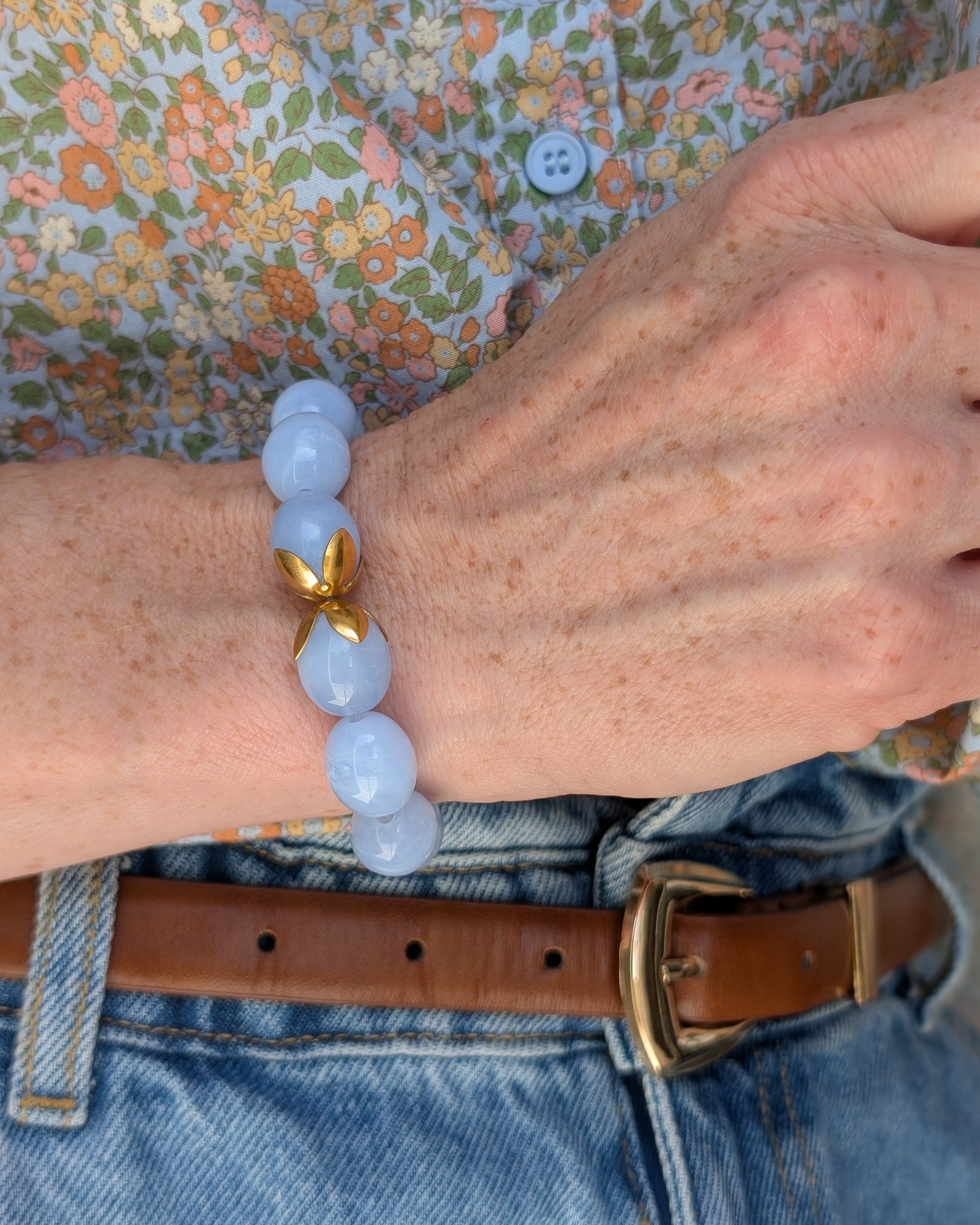 Bracelet Olivia perles résine bleu azur et acier inoxydable. Porté au poignet d'une femme. Créations artisanales La Tête dans les Nétoiles