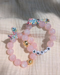 2 bracelets liberty glowy perles à paillettes rose clair et coeur doré. Orné d'un ruban liberty. avec message amour à personnaliser. Créations La Tête dans les Nétoiles 
