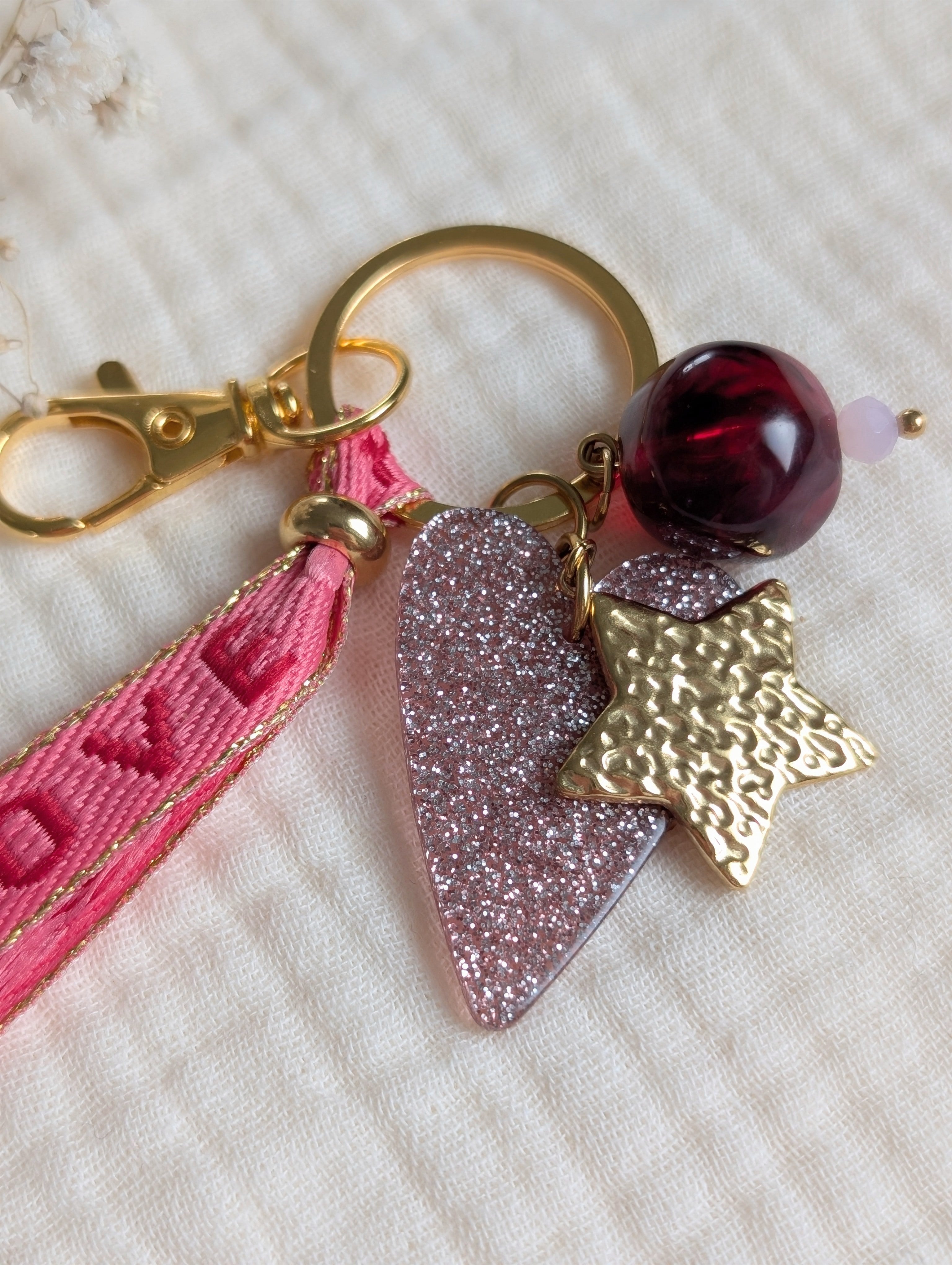 Bijou de sac romantique ruban rose LOVE avec étoile martelée et perles magenta grenat