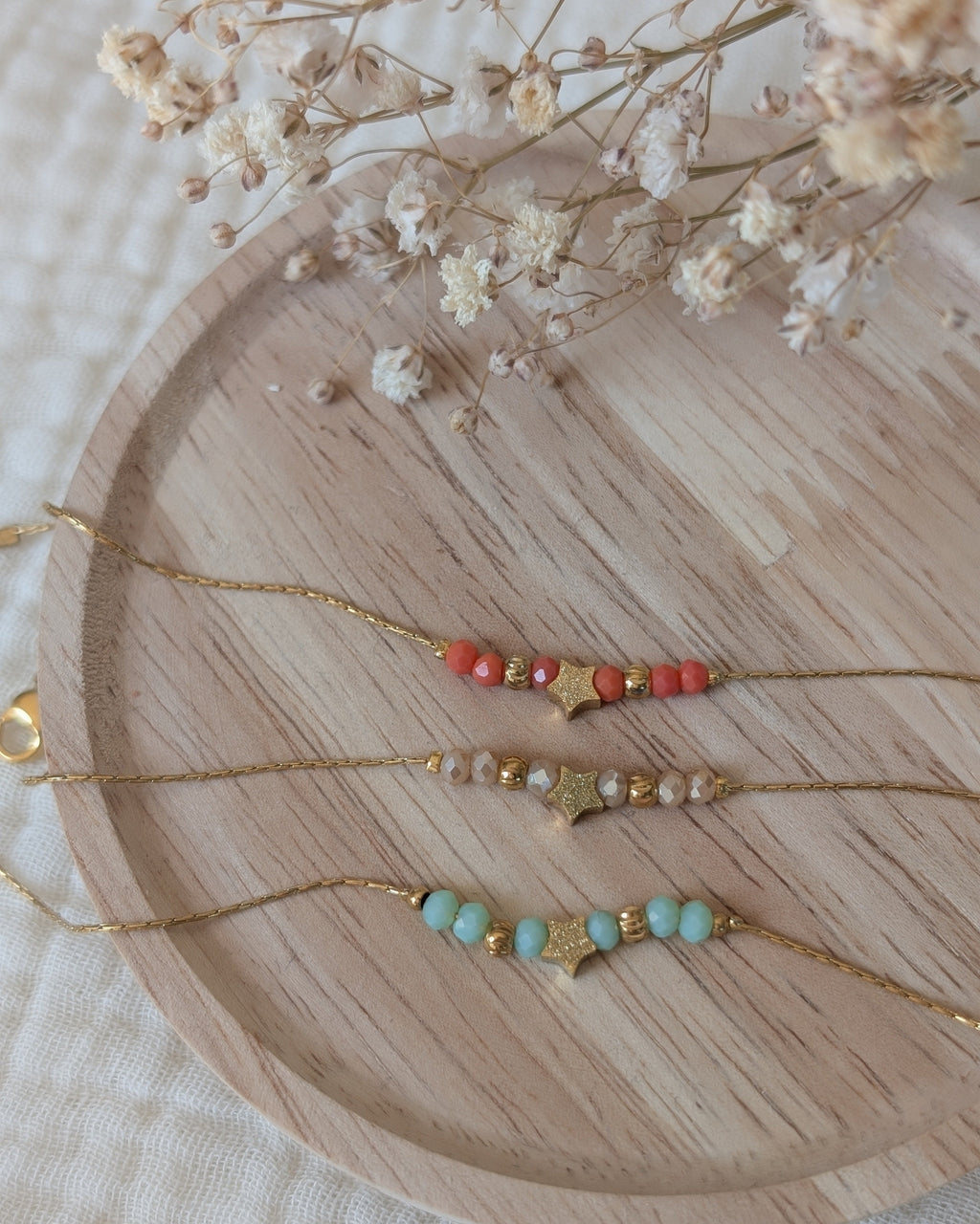 trio de bracelets fins en maille serpentine. 3 couleurs un en corail orange/ un en nude et un en vert d'eau. Créations en acier inoxydable doré. La Tête dans les nétoiles